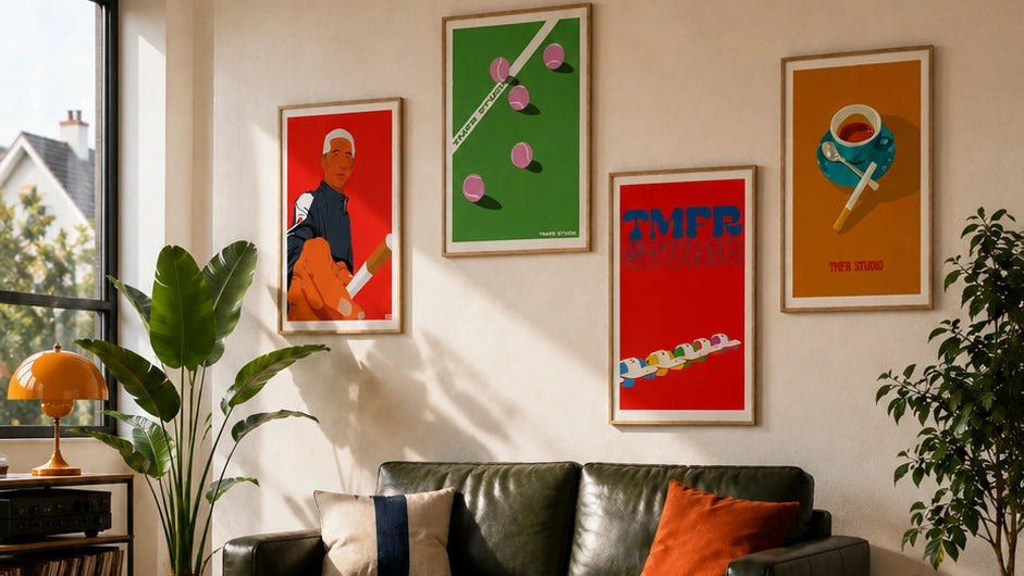 various poster displayed alongside three other TMFR Studio posters in a colorful gallery wall above a green sofa
