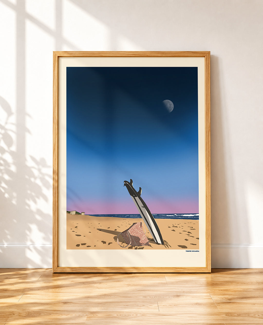 framed Illustration of a surfboard standing upright in beach sand at dusk with a beach bag, ocean waves, and a half moon in the sky
