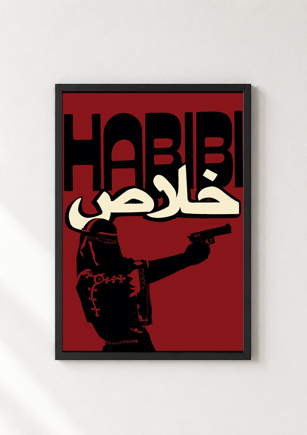 Black framed Habibi Khalas poster with a veiled figure holding a gun on a red background
