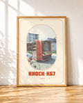 framed Vintage poster of an orange K67 street kiosk with a cyclist passing by, featuring Cyrillic Kiosk K67 text
