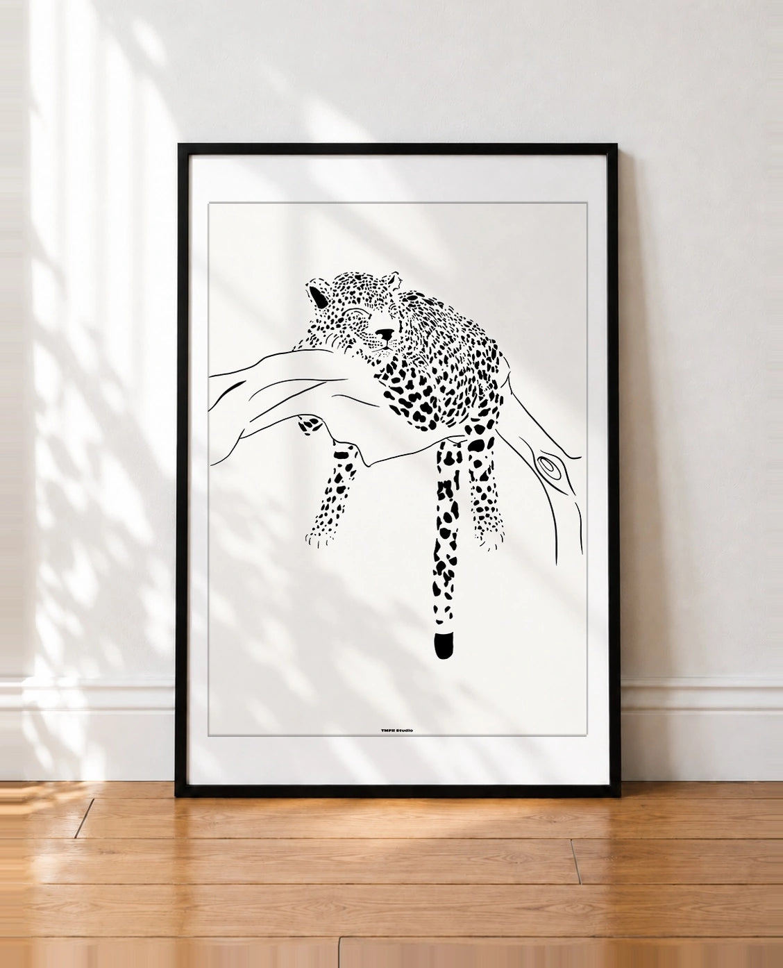 framed Black and white line illustration of a leopard sleeping on a tree branch with its tail hanging down
