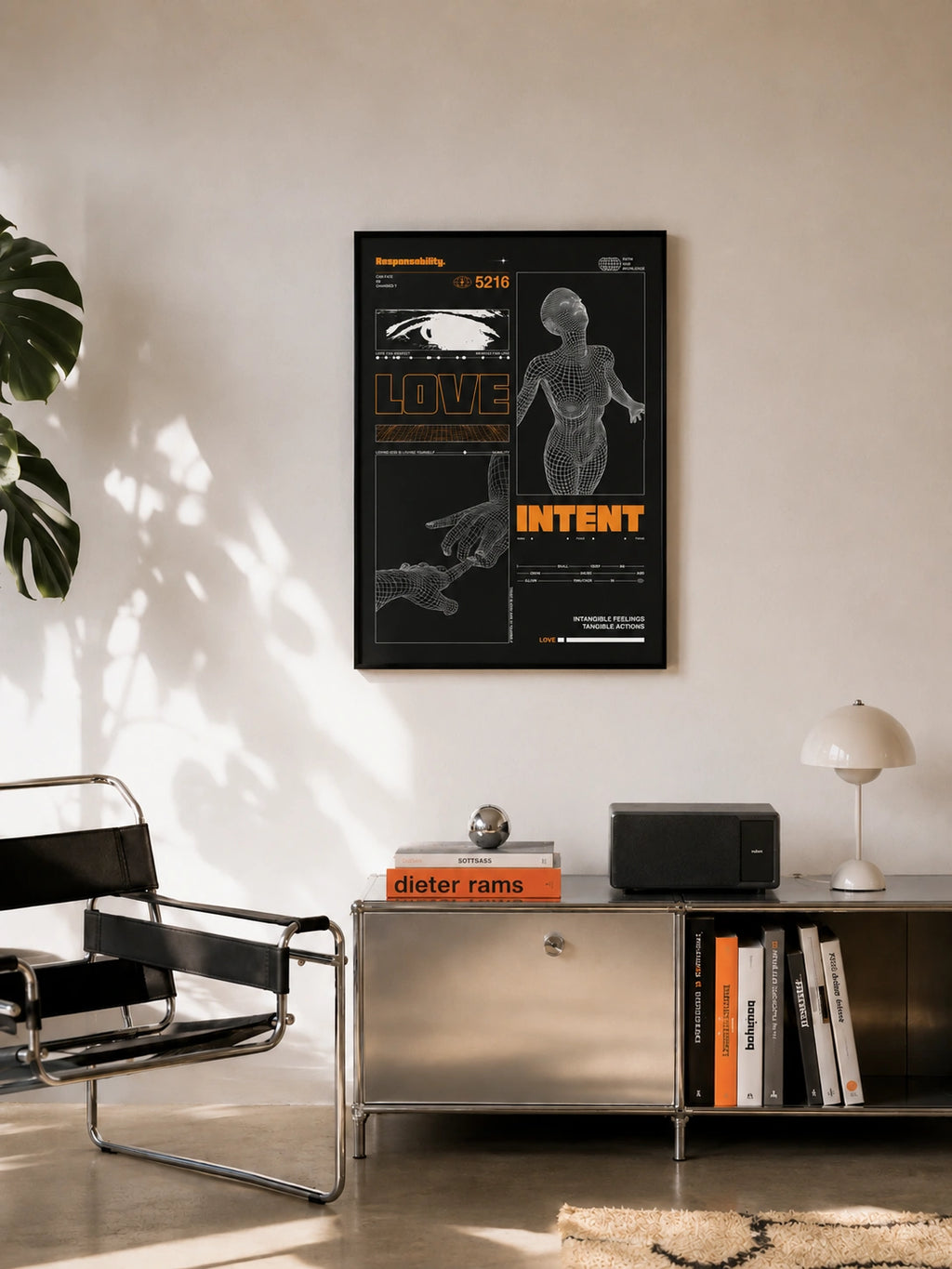 Love and Intent framed poster hanging above a metal credenza in a modern living room with design books
