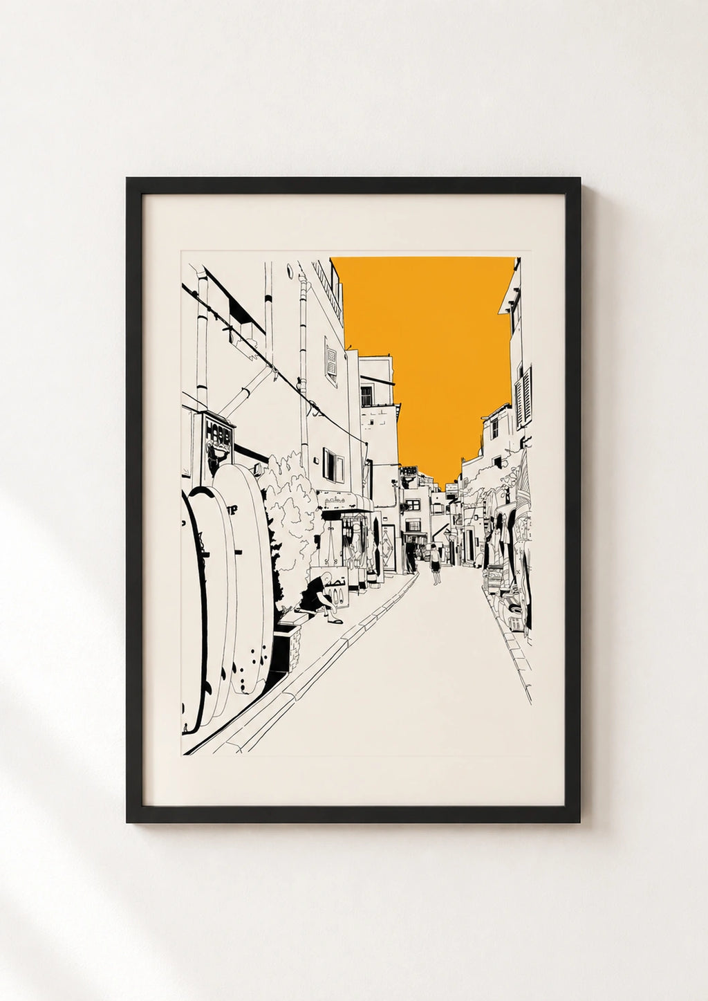 Black framed Taghazout street print with surfboards and an orange sky
