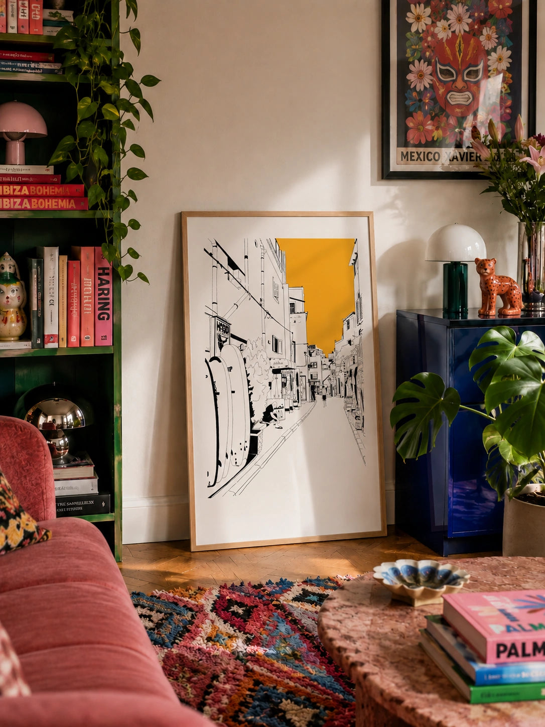 Moroccan street view framed poster in a colorful eclectic living room with a patterned rug and plants
