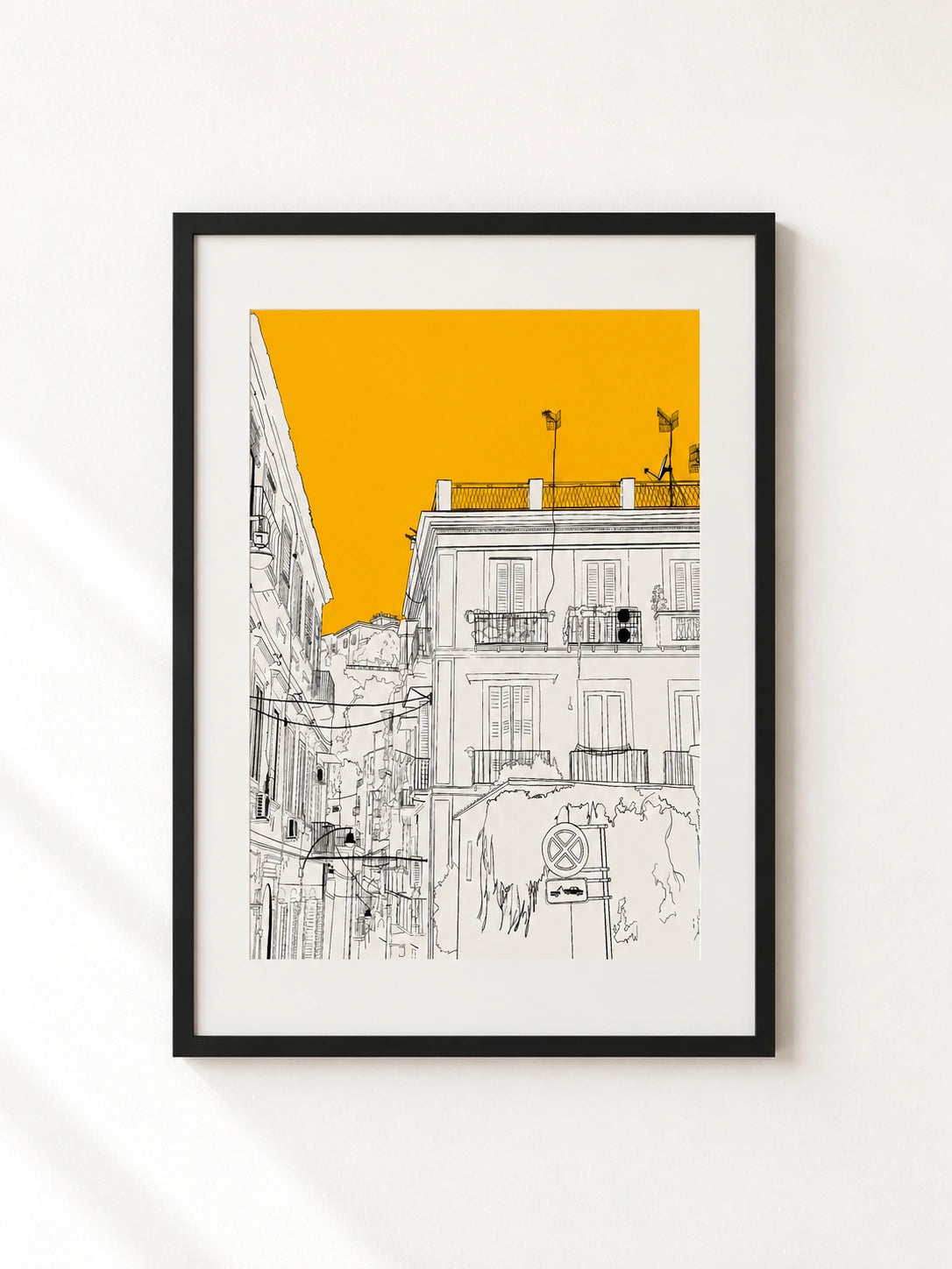 Black framed print of a Naples building facade illustration with an orange sky and balconies
