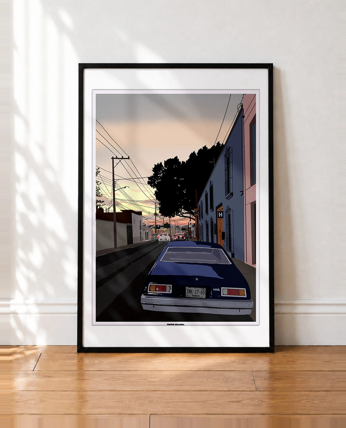 framed Illustration of an Oaxaca street at dusk, colorful pink and blue facades, power lines, a silhouetted tree and a blue Chevrolet Nova seen from behind in the foreground