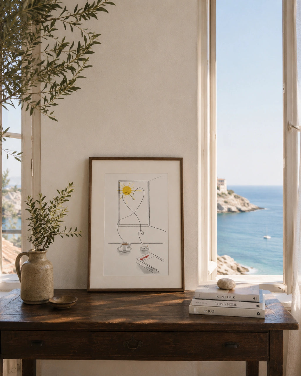 Old Love Story framed poster on a wooden table with a view of the sea and rooftops
