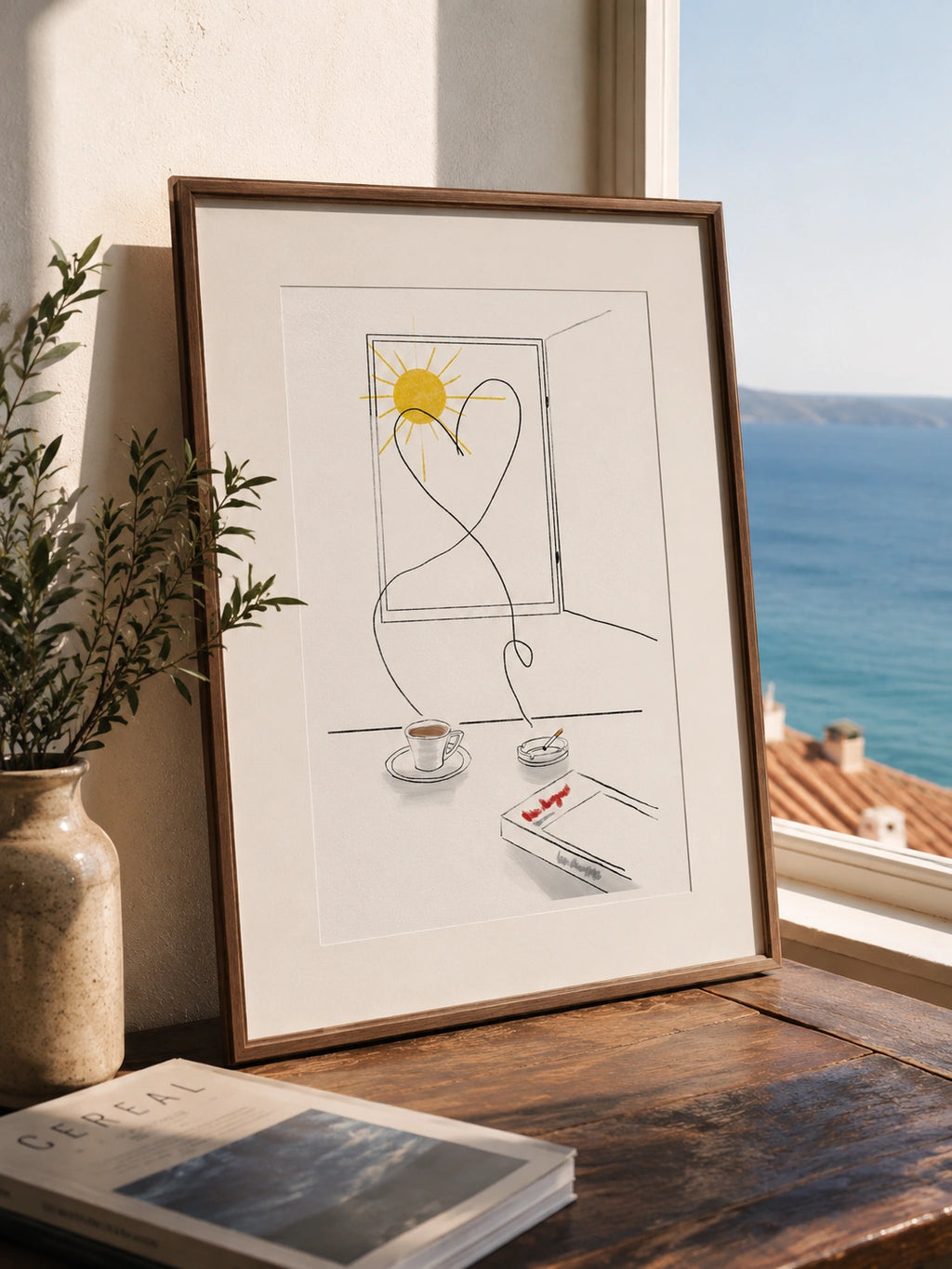 Old Love Story framed poster on a console table near open windows overlooking the coast
