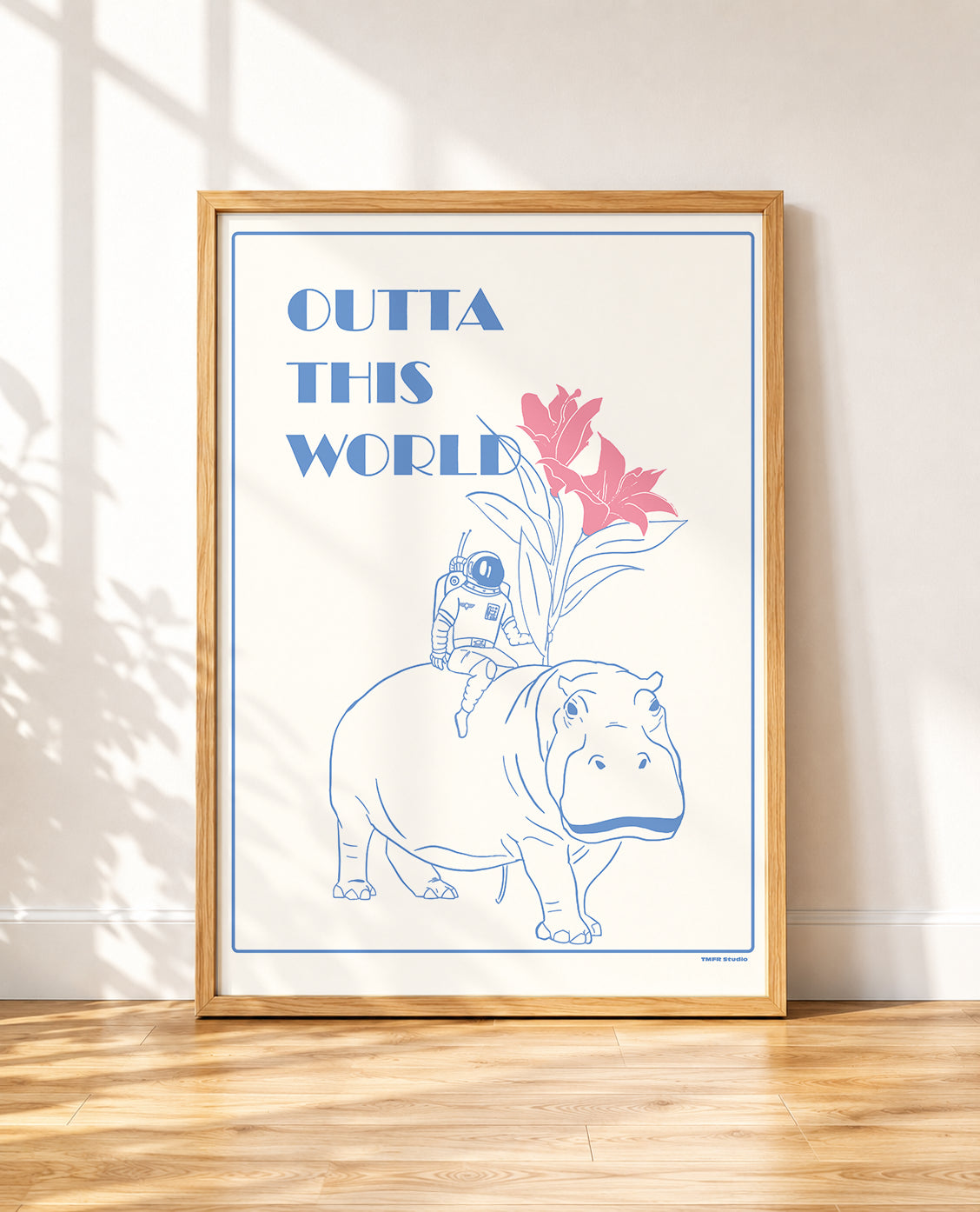 Outta This World framed poster with an astronaut on a hippo leaning against a wall in a bedroom
