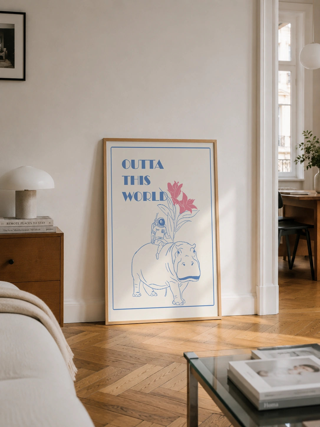 Outta This World framed poster with an astronaut on a hippo leaning against a wall in a bedroom
