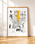 A framed art print featuring a black and white street scene illustration with a bold yellow vertical highlight, displayed in a light wood frame against a white wall on a wooden floor.